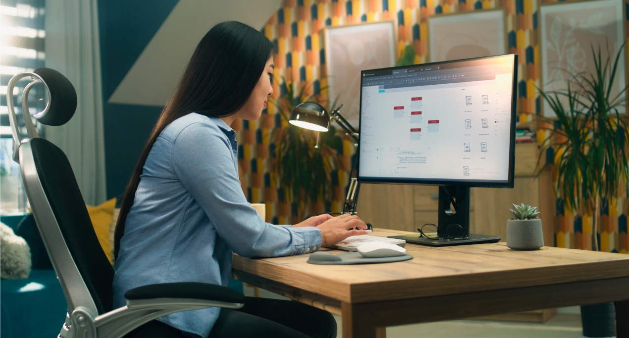 Designer working on creative web site designs on desktop computer